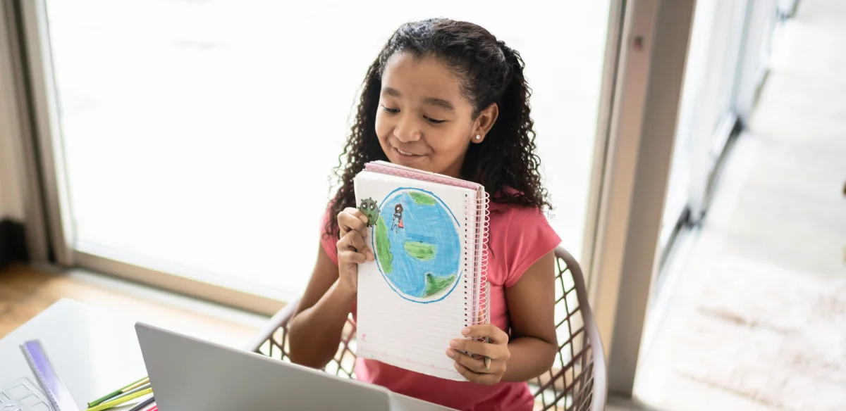 girl showing a map in front of the computer