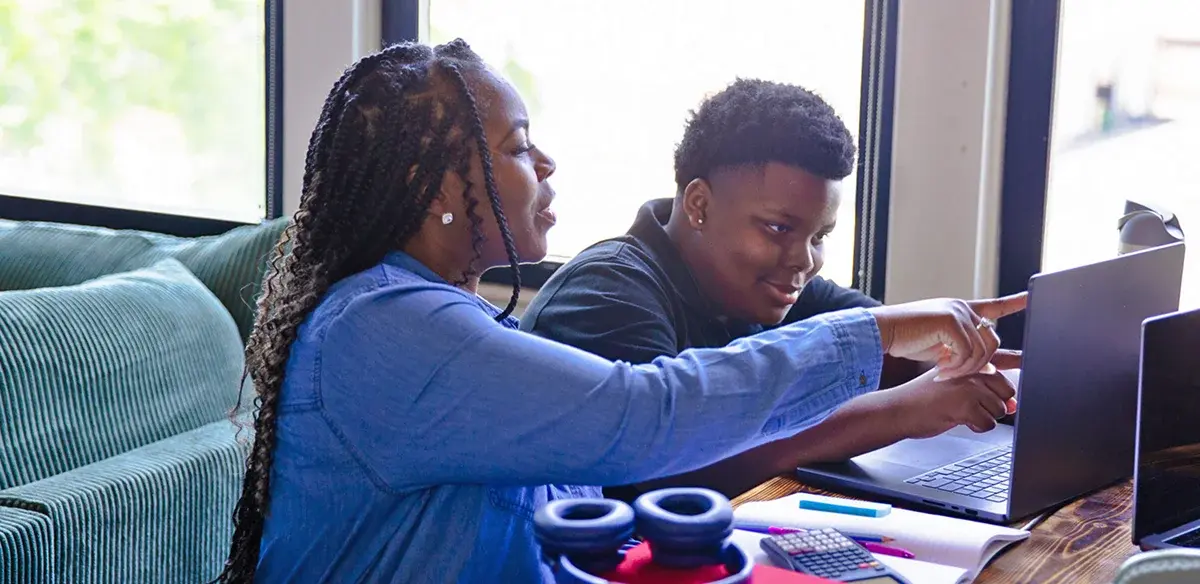 Mother and son working with their laptop